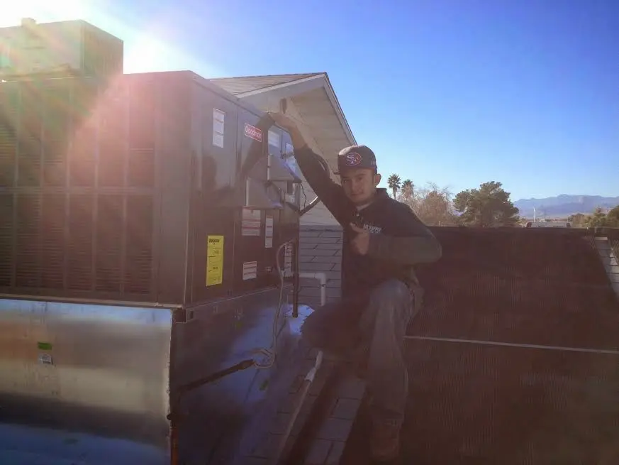 HVAC technician performing HVAC Inspection on a rooftop unit in Twin Falls